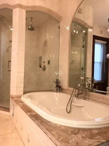 Bathroom with a soaking tub and glass shower