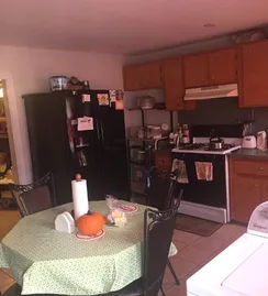 Kitchen before the remodel, table and old appliances